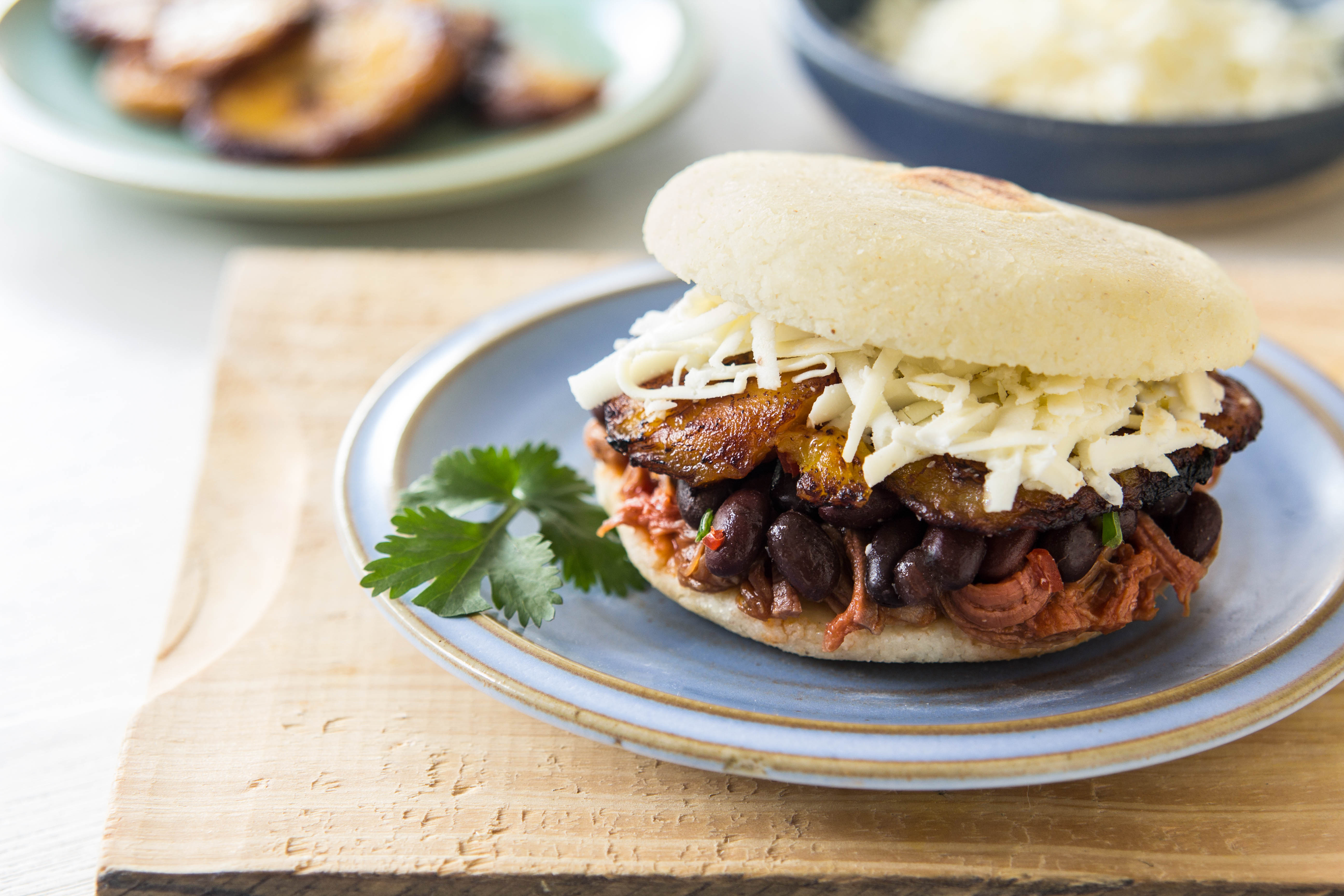 Arepa Filled with Shredded Beef, Black Beans, Fried Plantain & White Cheese