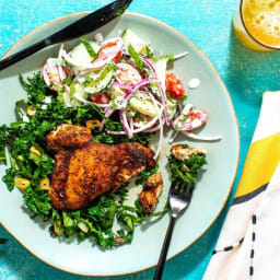 Baharat chicken over wilted kale with tzatziki-cucumber salad