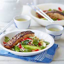 Crispy Asian salmon with stir-fried noodles, pak choi and sugar snap peas