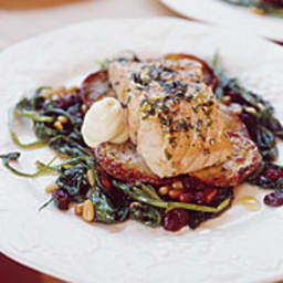 Herb and Lemon Roasted Salmon on a Bed of Roasted Potatoes and Sauteed Gree