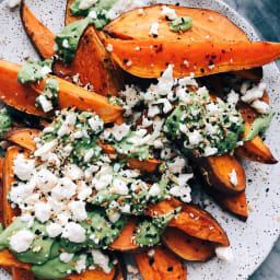 Slow Roasted Sweet Potatoes Covered in Green Sauce