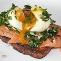 Soft-boiled egg with smoked trout and fresh herds