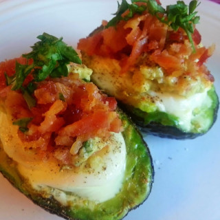 Baked Eggs in Avocado with Guacamole, Parmesan Cheese, and Bacon