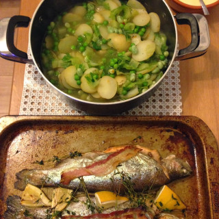 Baked whole trout, with jersey royals, peas and mustard sauce