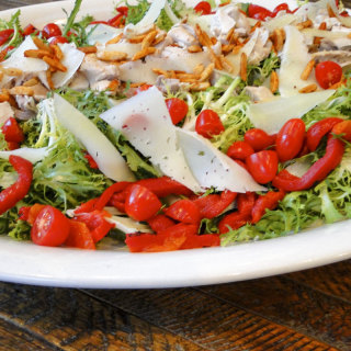 Chicken frisee salad with roasted peppers, manchego and Spanish paprika