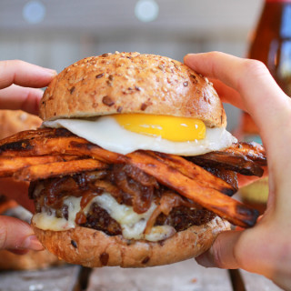 Epic Crispy Quinoa Burgers Topped with Sweet Potato Fries, Beer Caramelized
