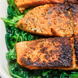 Pan Seared Salmon with Orange Juice, Wilted Spinach and Arugula