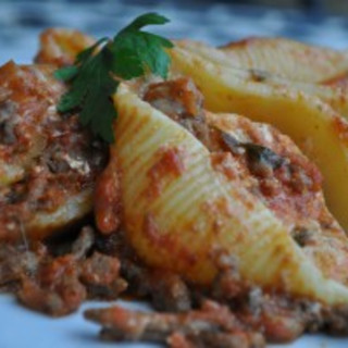 Pasta shells filled with ricotta and baked in a tomato meat sauce