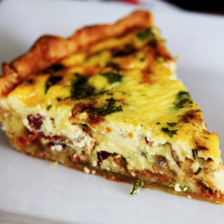 Quiche lorraine with shallots in a bed of emmental