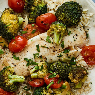 Tilapia in Parchment With Tomato and Broccoli Over Rice