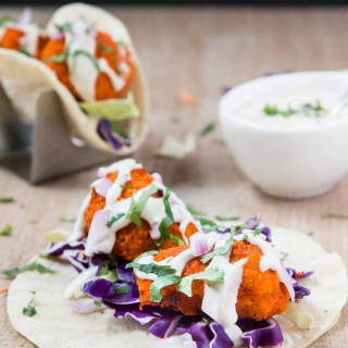 Vegan Buffalo Cauliflower Tacos with Cucumber Ranch, Slaw, Red Onions, and 