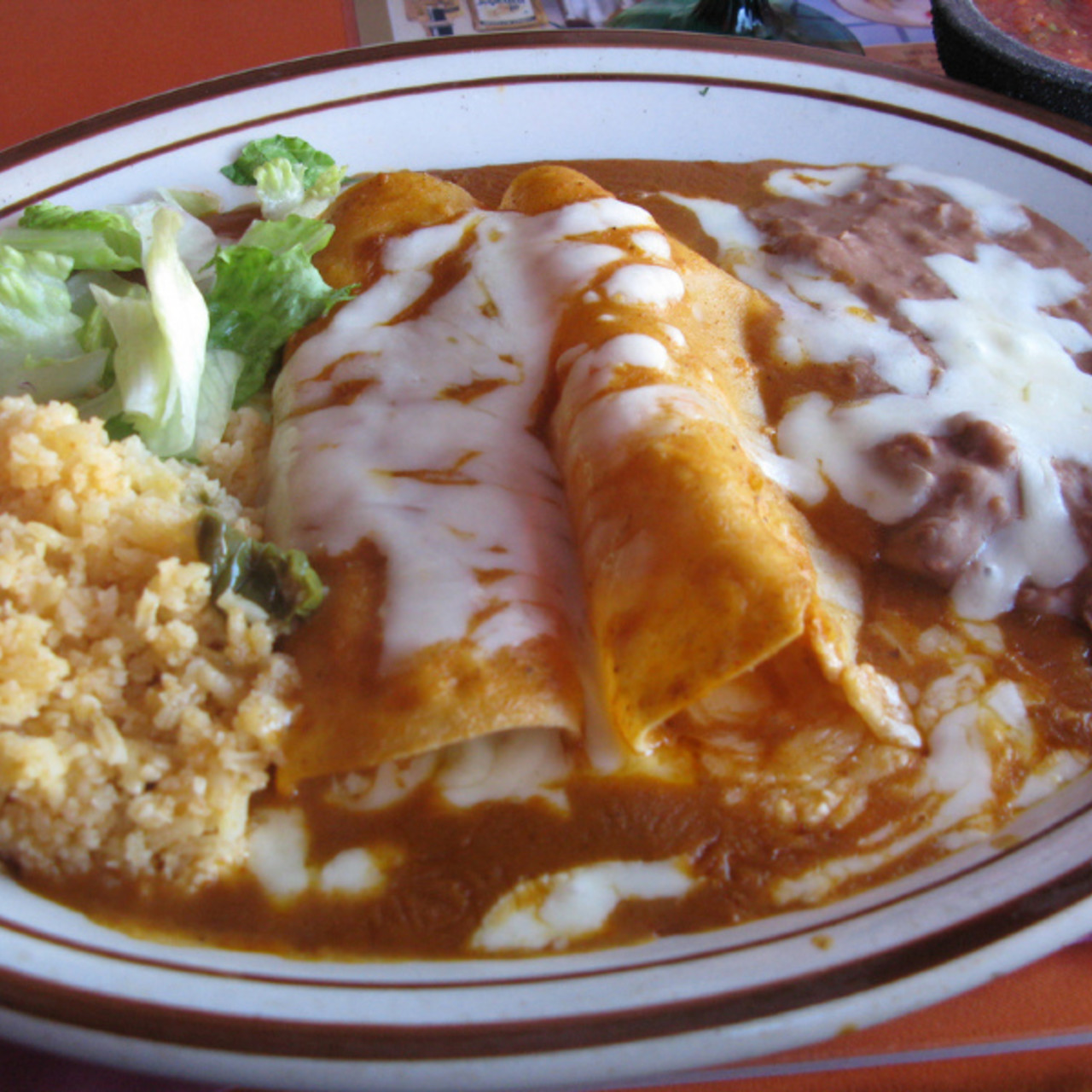 chicken-enchiladas-with-mexican-rice-and-re-fried-beans-integrated-meal