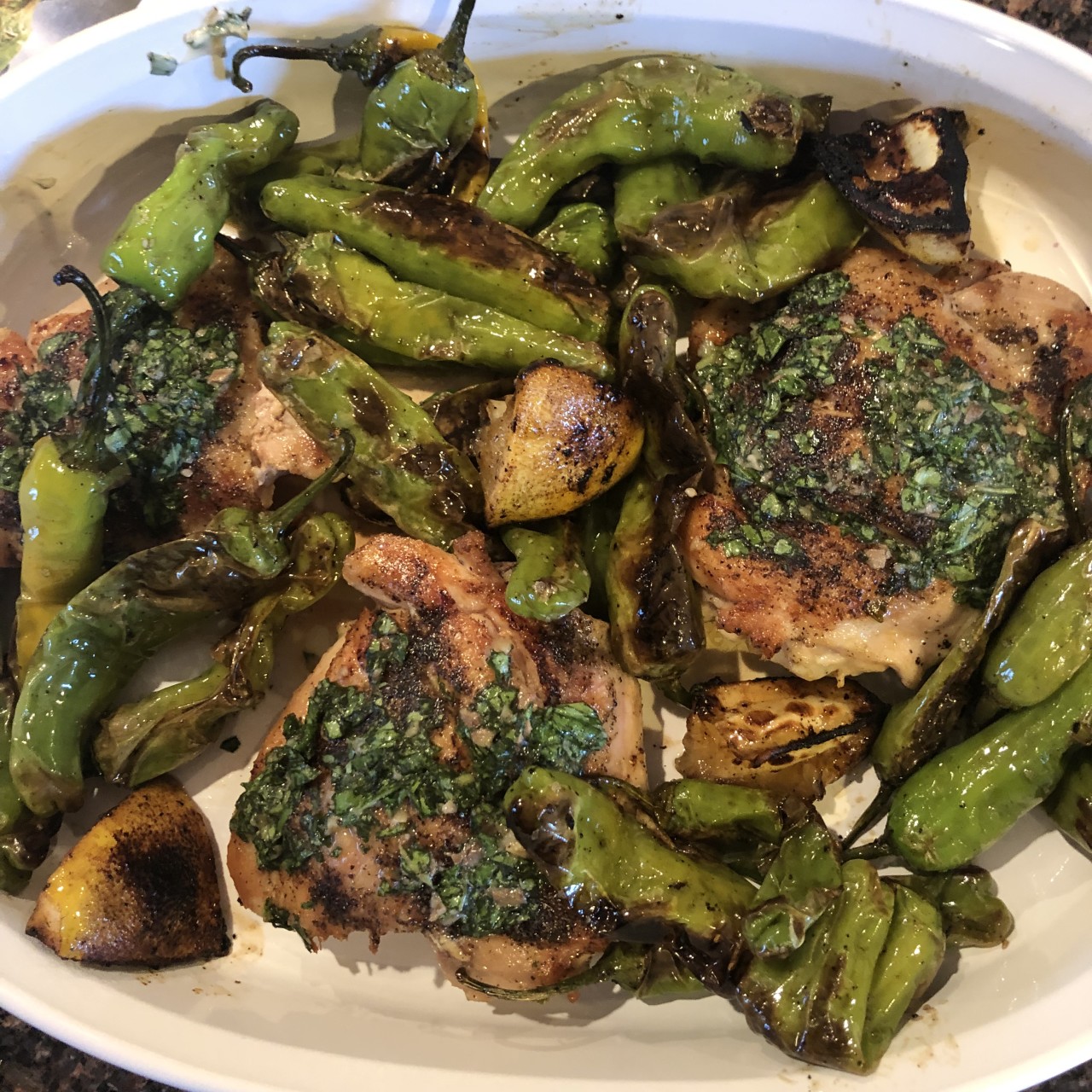 Chicken with basil anchovy butter and Shishito peppers
