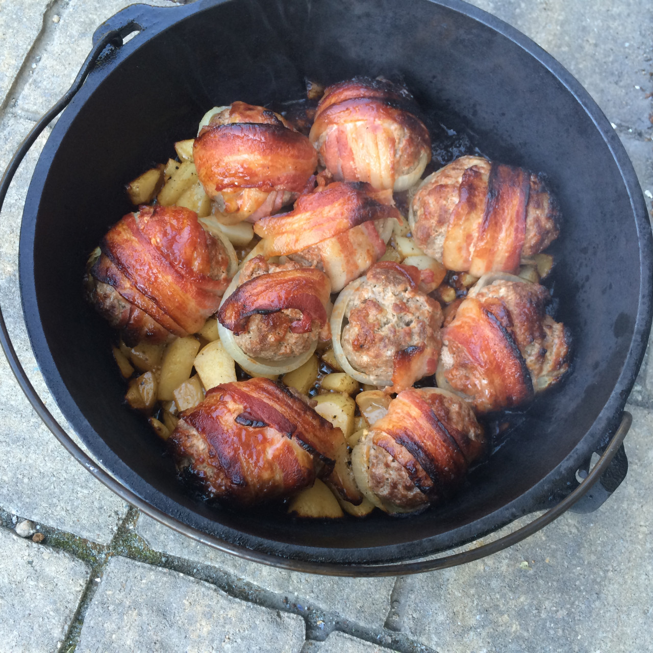 Dutch Oven BBQ Bacon Wrapped Stuffed Onion Bombs and Potatoes