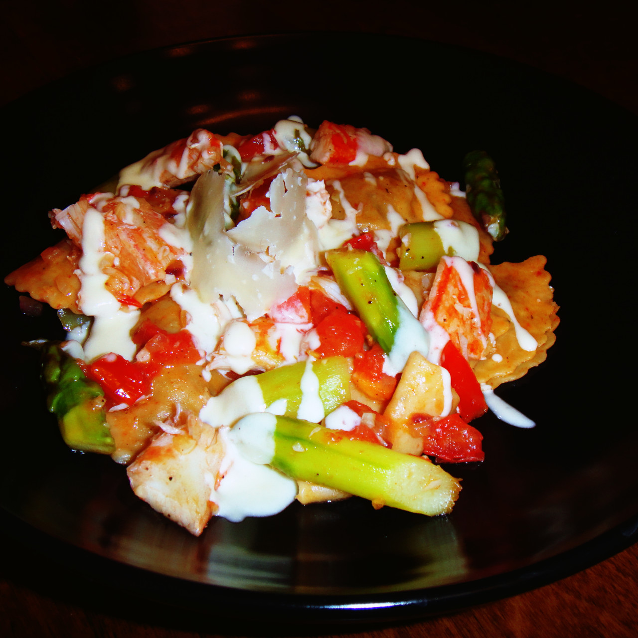 Mushroom ravioli with crab, asparagus, tomatoes and white wine cream sauce