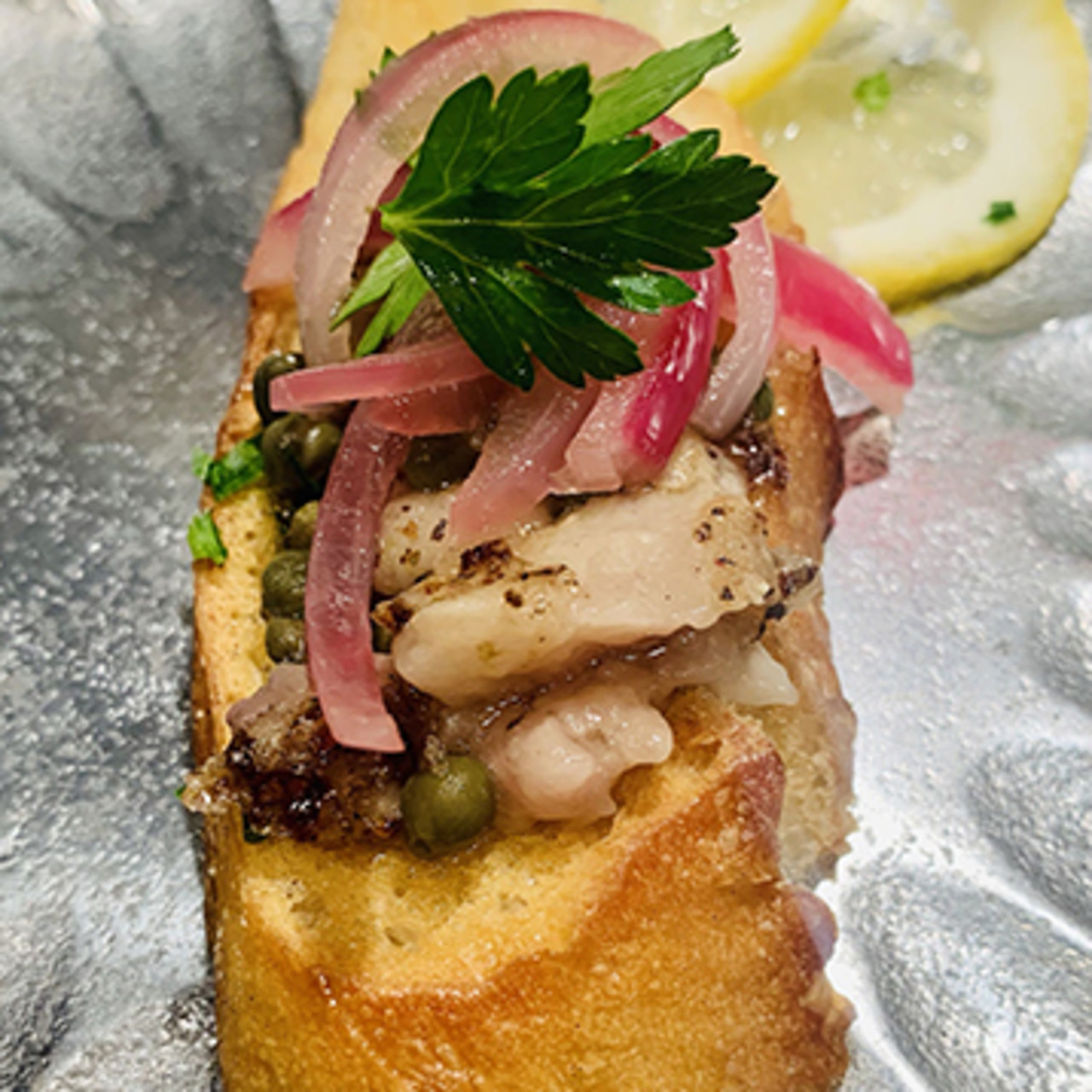 Wagyu Bone Marrow on Toast with Red Onion, Capers, and Lemon