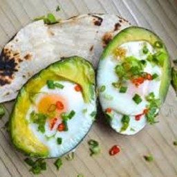 Baked eggs in avocado with pitta 