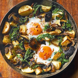 Baked eggs with mushrooms, potatoes, spinach and Gruyère