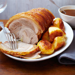 Herb-studded roast loin of pork with apple and cider gravy