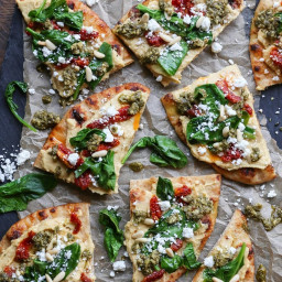 Hummus Flatbread with Sun-Dried Tomatoes, Spinach, and Pesto