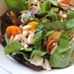 Mixed Greens Salad with Caramelized Onion, Tomato, Feta and Toasted Almonds