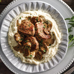 Pork with Mushrooms and Brie Sauce Over Mashed Potatoes