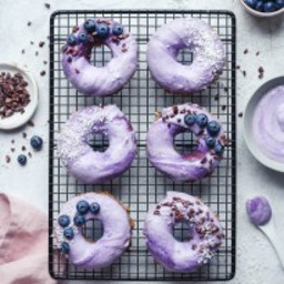 Raw vanilla donuts with blueberry glaze