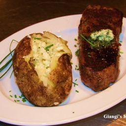 Steak with baked potatoes with cheese and butter