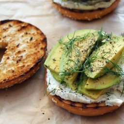 Toasted bagel with dill cream cheese  and  avocado