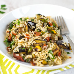 Warm brown rice salad with roasted aubergine and pistachios