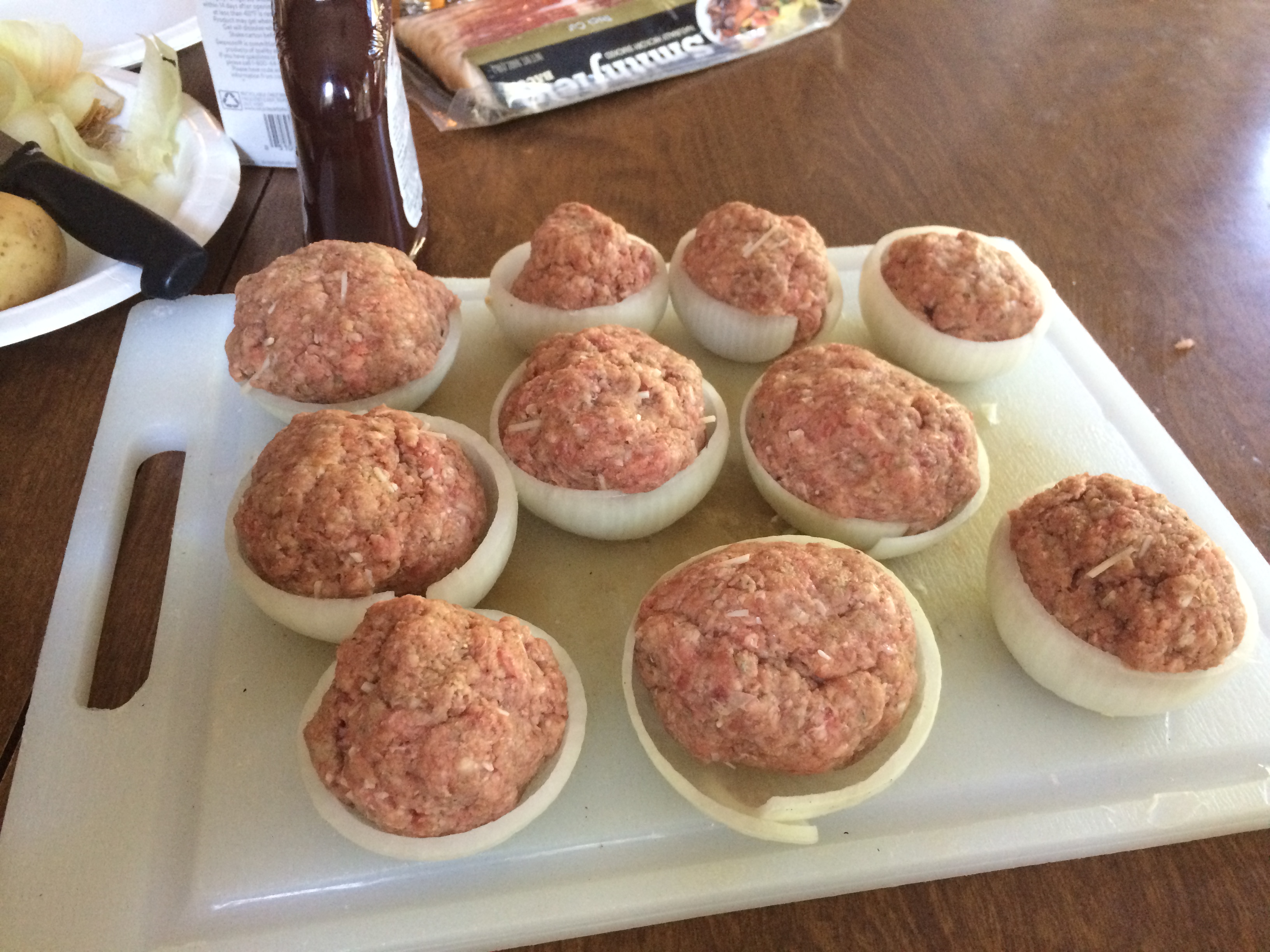 Dutch Oven BBQ Bacon Wrapped Stuffed Onion Bombs and Potatoes