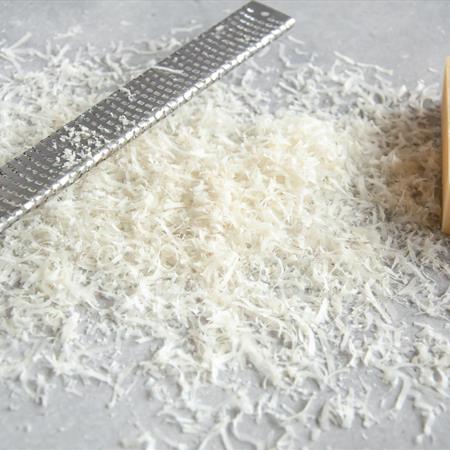 grated parmesan with grater on countertop