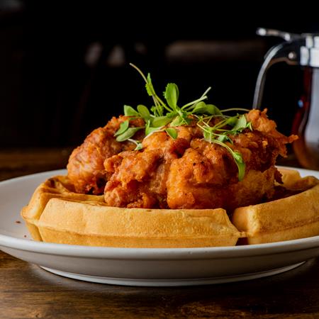 chicken and waffles on a plate side view
