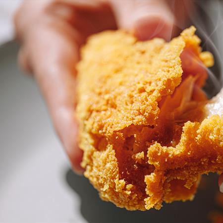 fried chicken being split open after cooking
