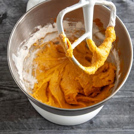 batter for pumpkin cinnamon rolls in stand mixer bowl