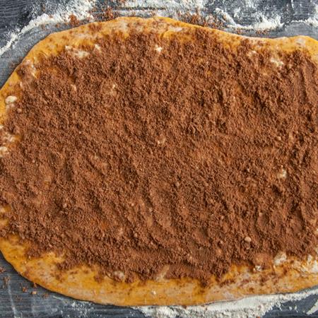 flat lay of batter rolled out with center fillings on batter ready to be rolled