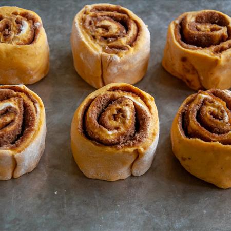 baked cinnamon rolls on a sheet pan from the side