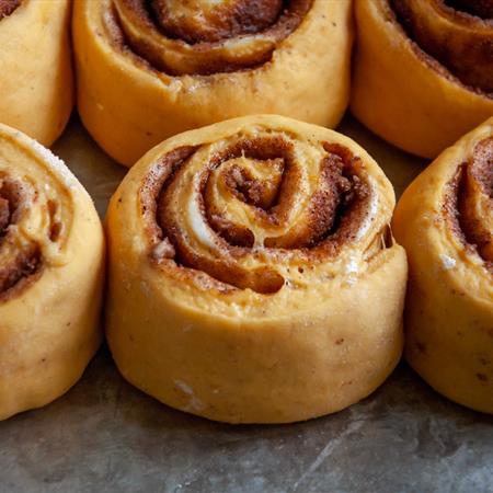 close-up of pumpkin cinnamon rolls after baking from side view