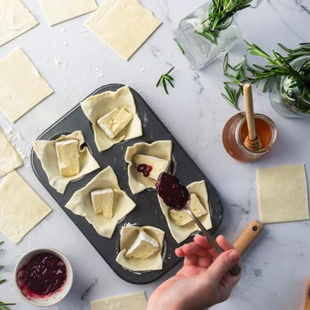 filing cranberries into dough cups