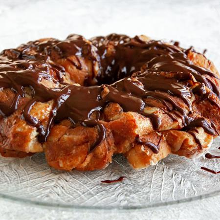 donut monkey bread recipe on a plate with a white background from slightly elevated side view