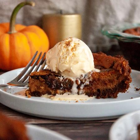 pumpkin nutella pie recipe on plate with vanilla ice cream and fall decore in background